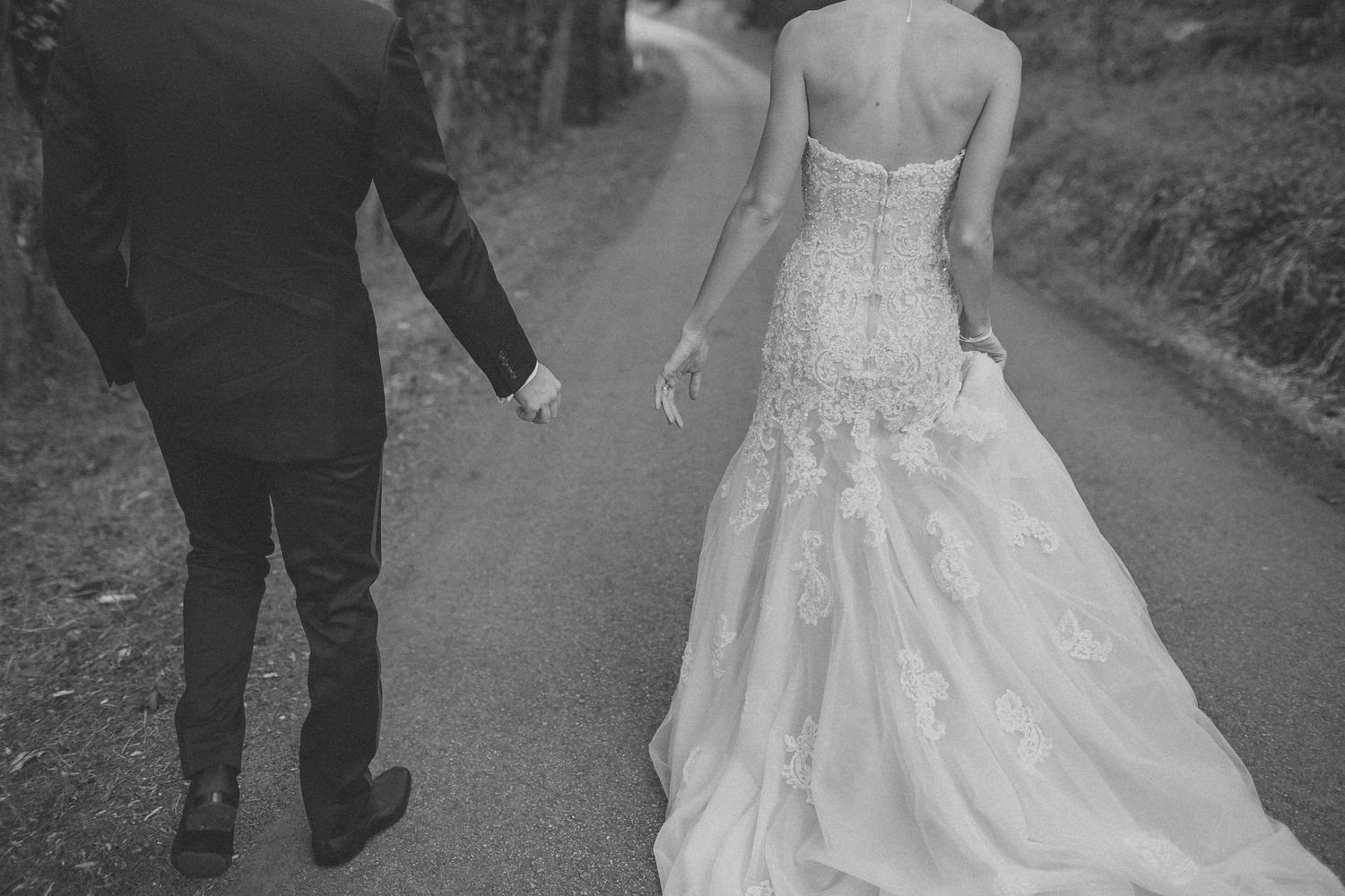 Bride and groom standing near a cliffside overlooking the coast in Northern California
