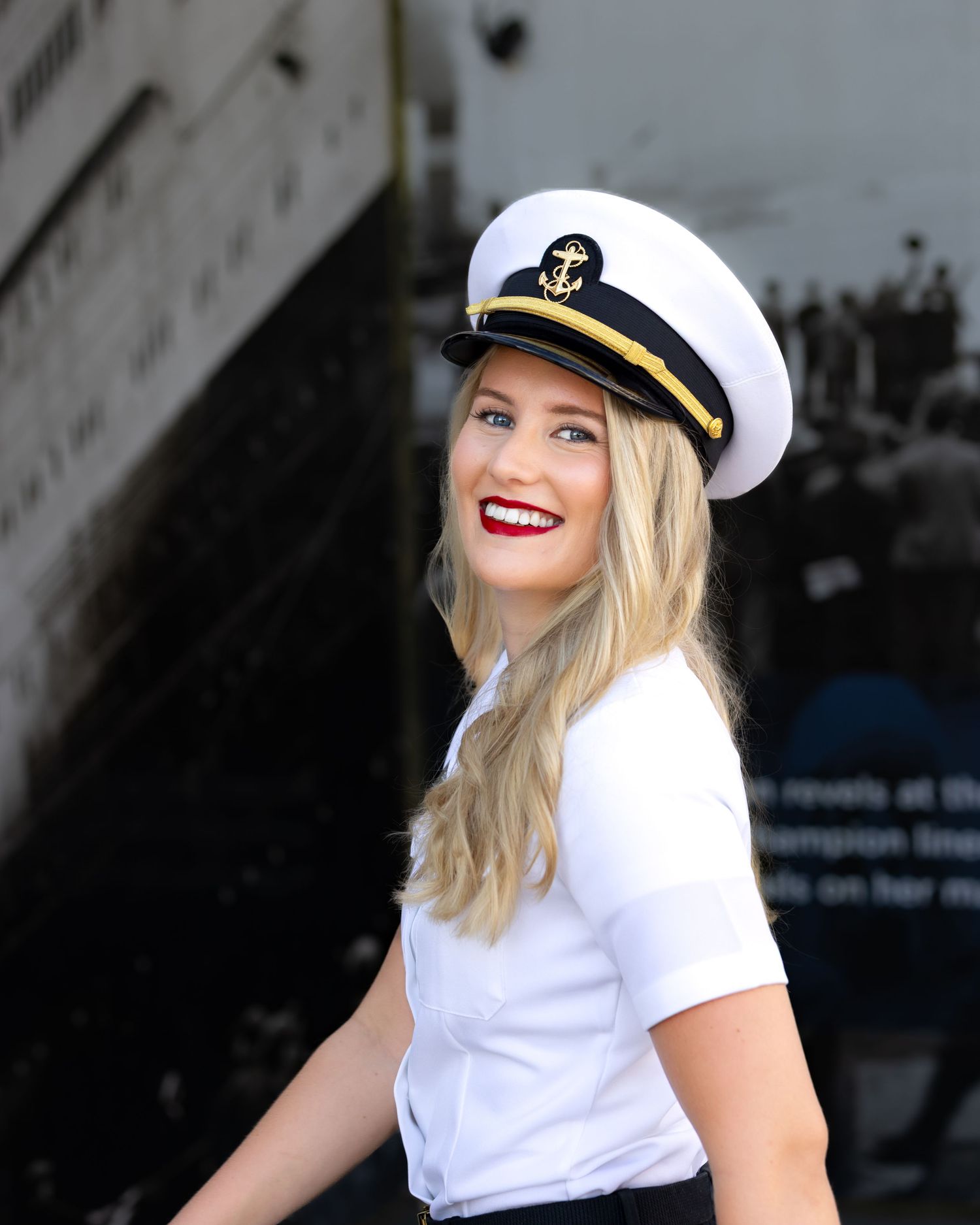 A person wearing a white naval captain's hat and white shirt poses in a series of expressive shots outdoors.