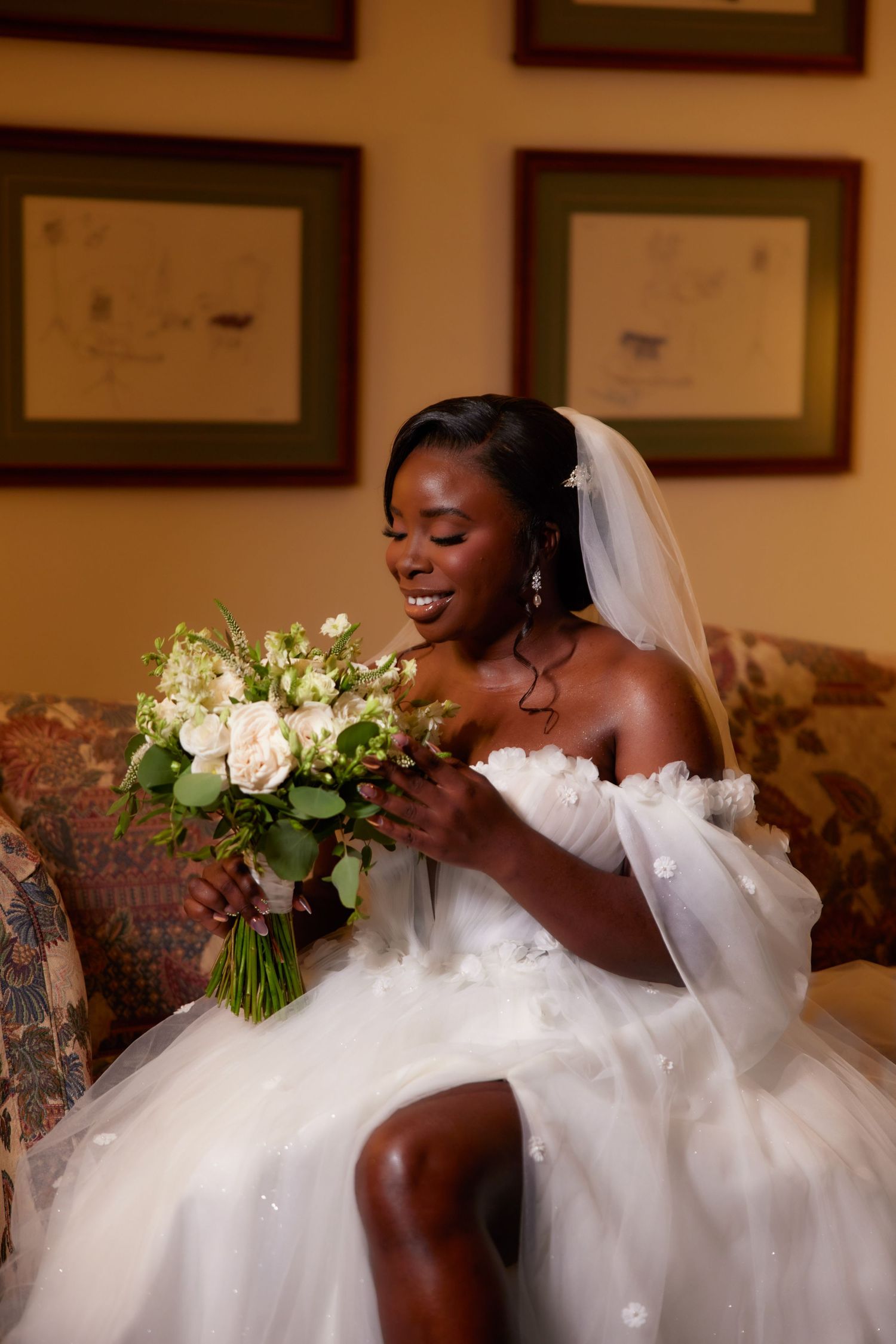 Beautiful bride laughs joyfully in sequence while wearing white ballgown wedding dress and holding floral bouquet.