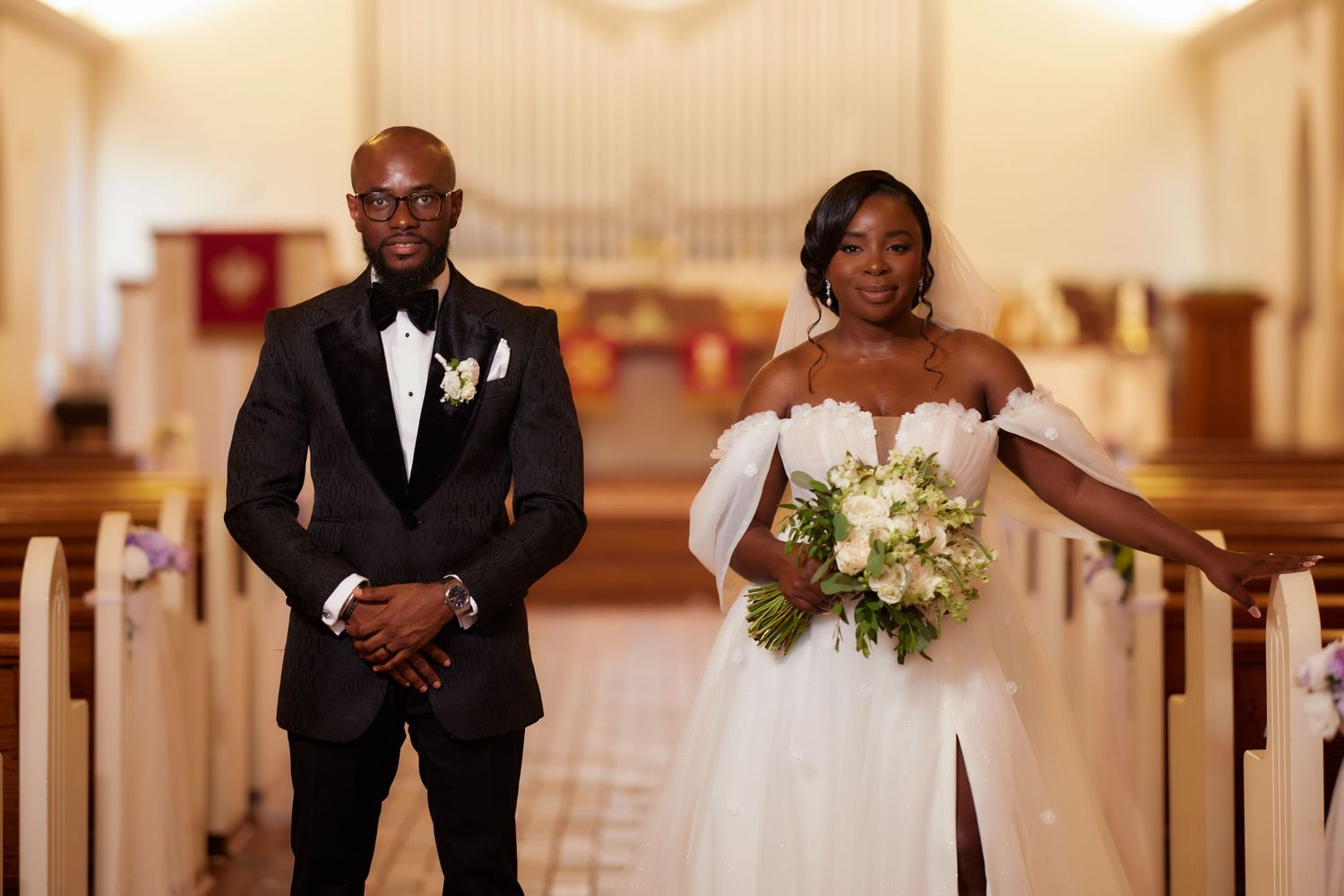 A wedding celebration in an elegant venue with people dancing and joyfully socializing at the reception.