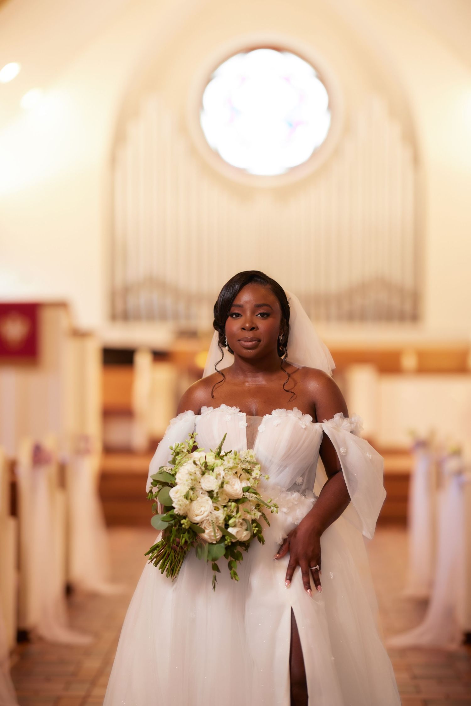 A beautiful bridal photoshoot in a grand church interior featuring a white wedding dress and floral bouquet.