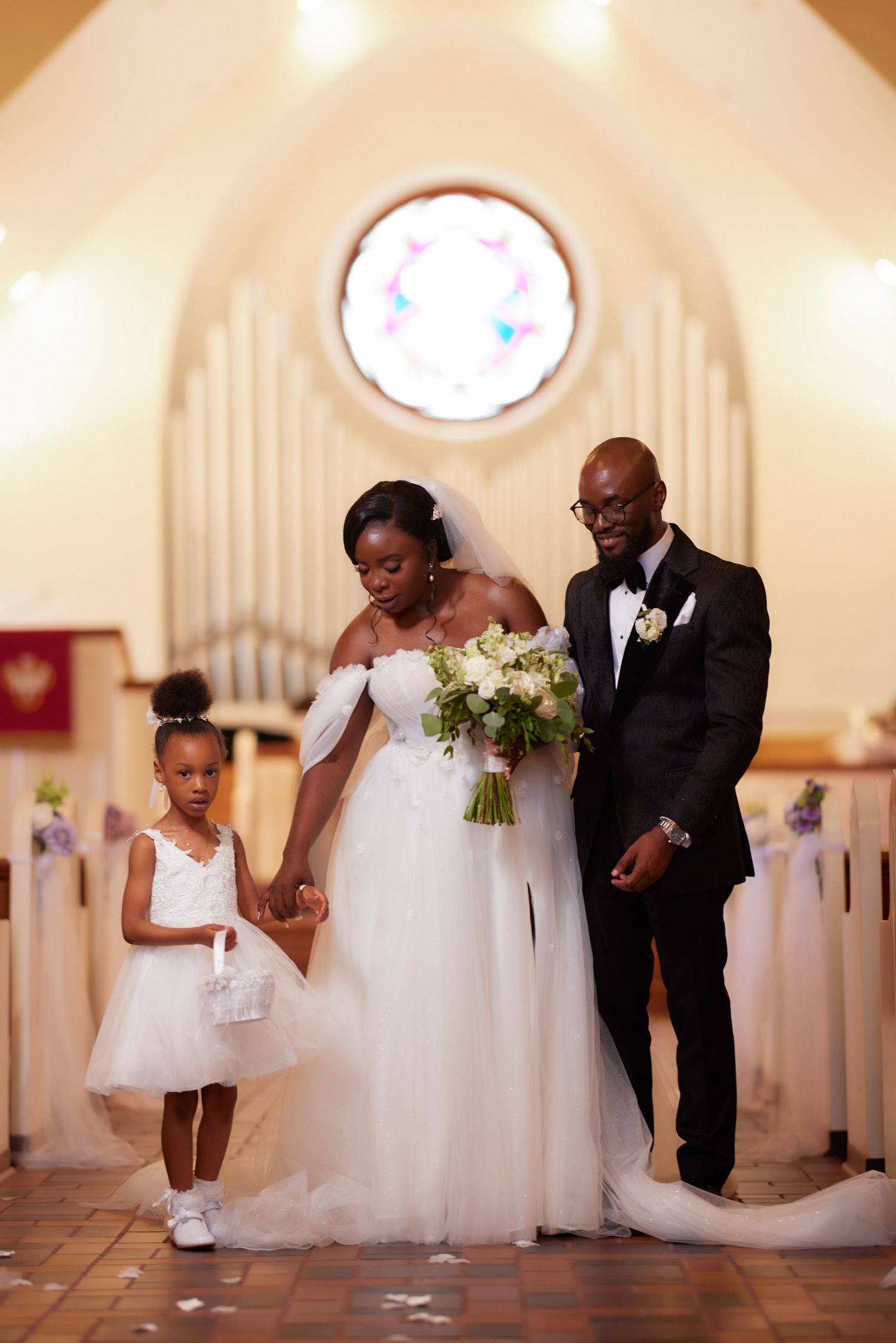 A collage of four romantic wedding ceremony moments in a white church interior with soft lighting.