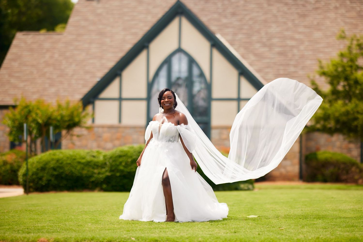 A wedding couple embraces in a romantic sequence across five photos on a lawn in front of a brick building.