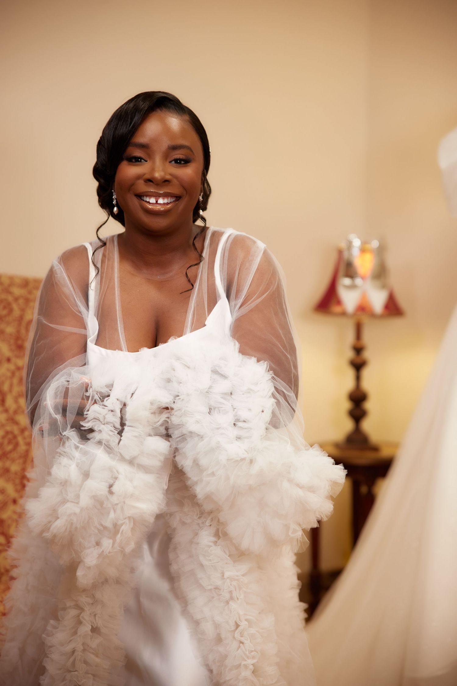 Luxurious white wedding attire with ethereal tulle details in a bridal boutique.