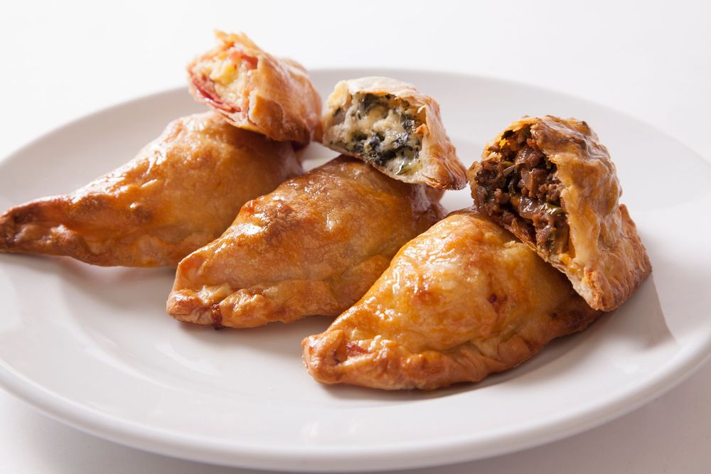 Golden brown baked chicken wings shown in a cooking progression from raw to fully cooked on white plates.