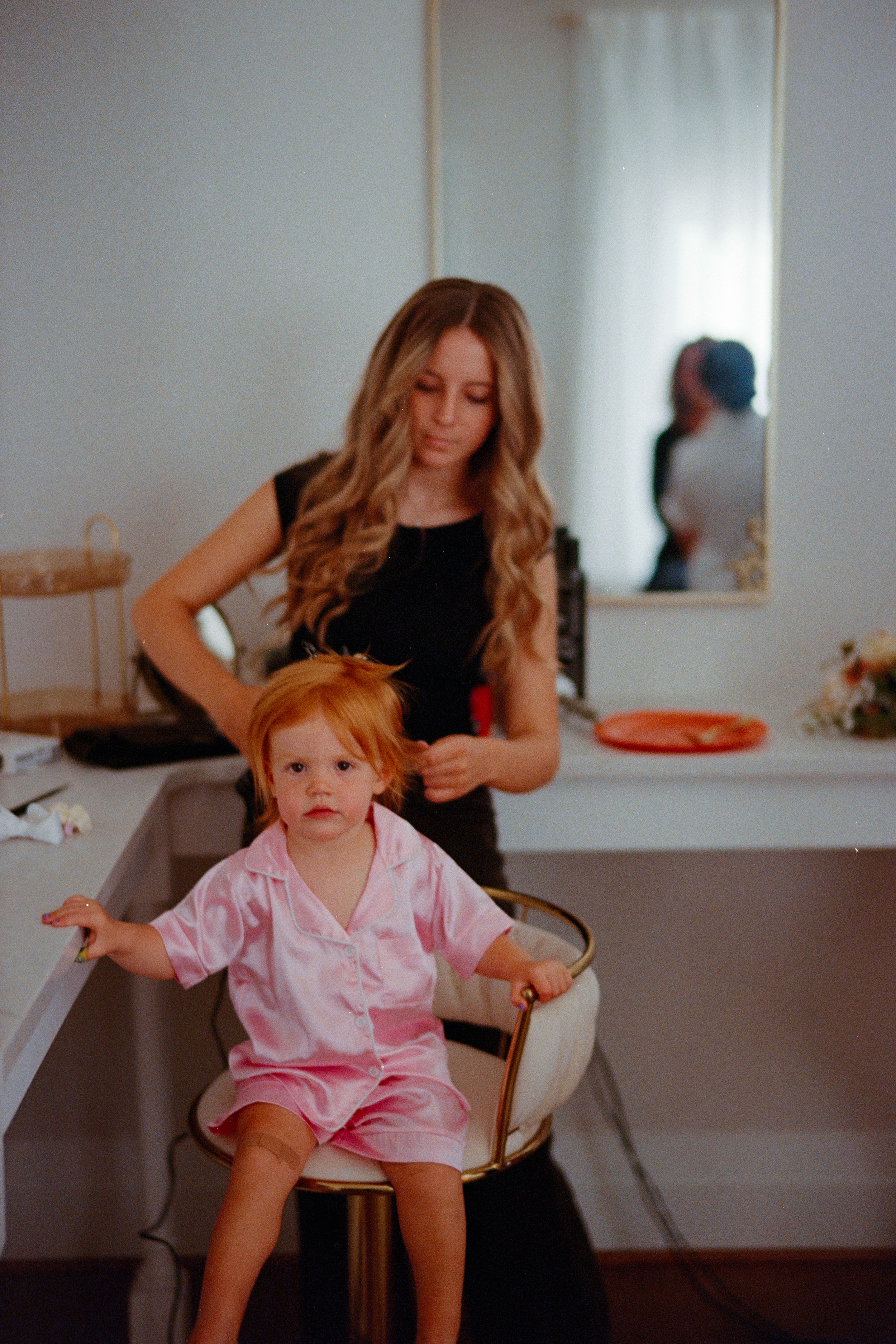 Three sequential photos show a small child in pink clothing playing and moving around in a bright indoor setting.