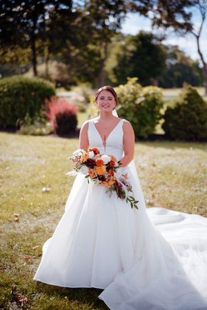 A series of outdoor bridal portraits showing a white wedding dress and autumn-colored bouquet in a sunny field setting.