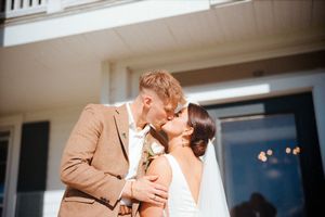 Multiple frames capture a tender wedding kiss moment between newlyweds in formal attire.