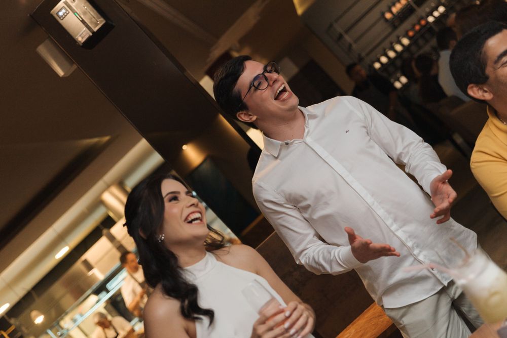 A candid moment of laughter and joy during a celebration in an indoor venue.