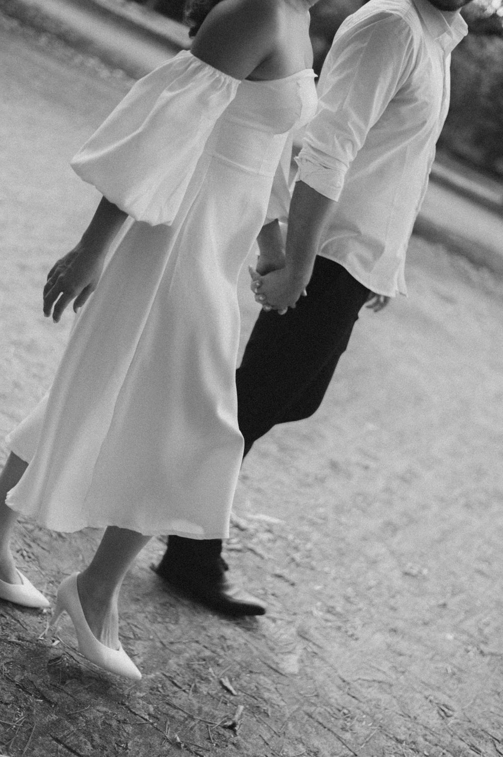 A black and white photo showing the movement of a couple in elegant attire.