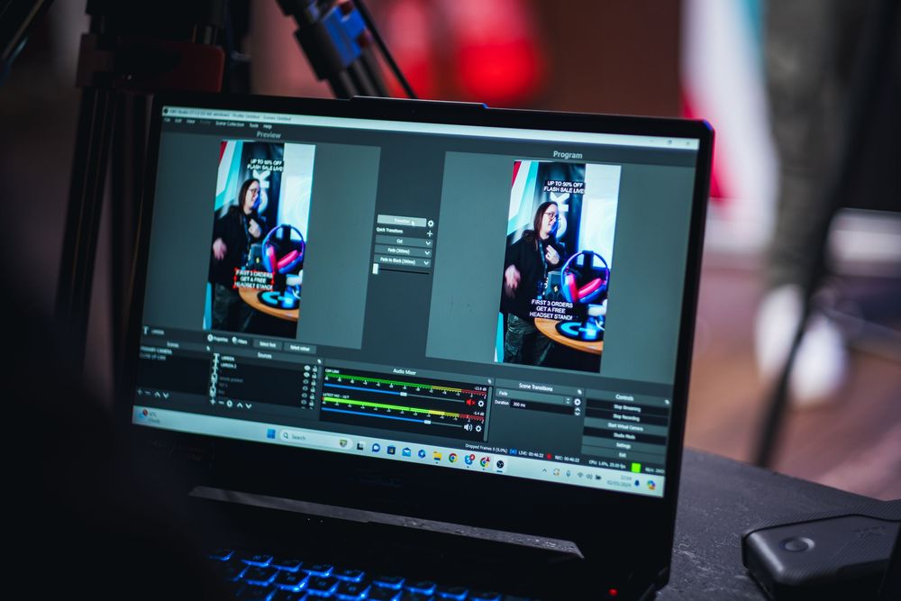 Video editing software interface displayed on multiple computer monitors.
