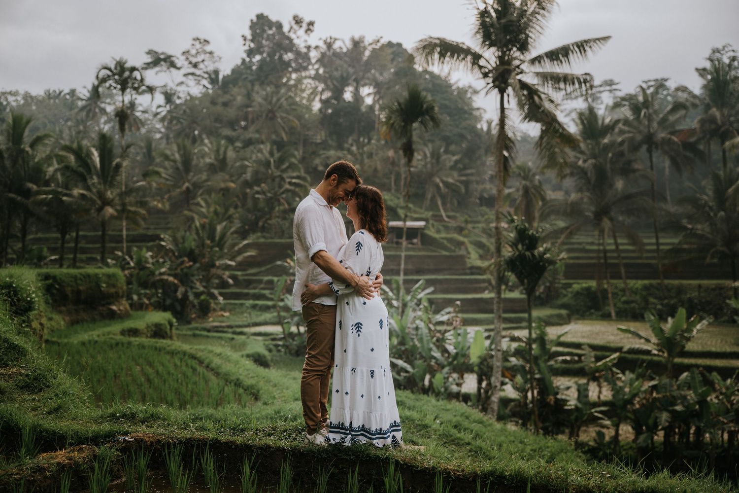 Romantic couple photoshoot overlooking lush rice fields
