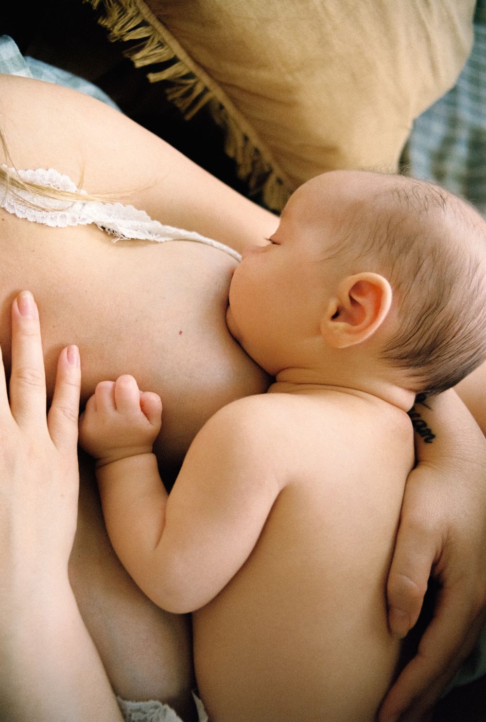 Close up series showing tender moments of skin-to-skin contact with a newborn baby.