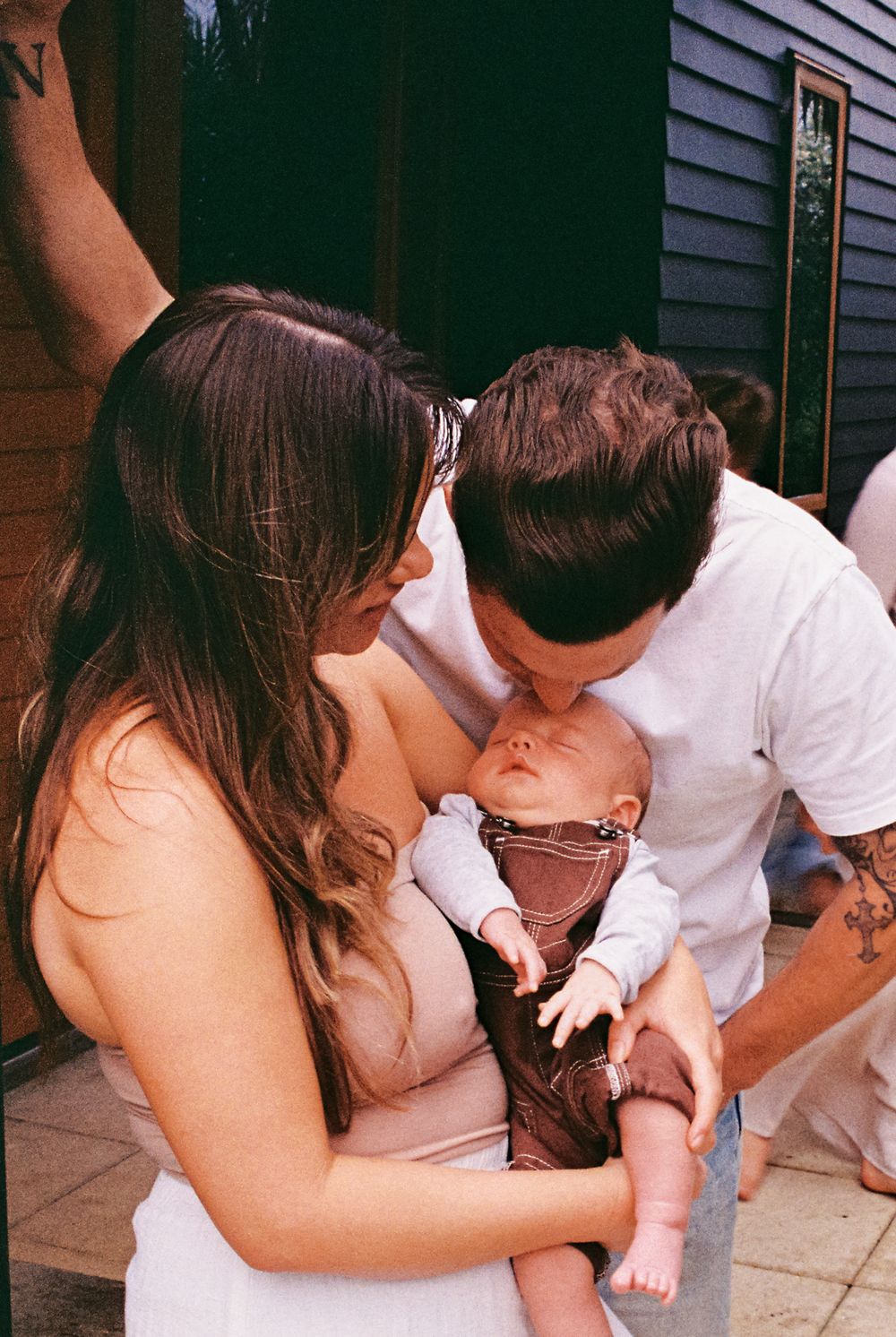 A tender family moment captured in multiple frames on an outdoor porch.
