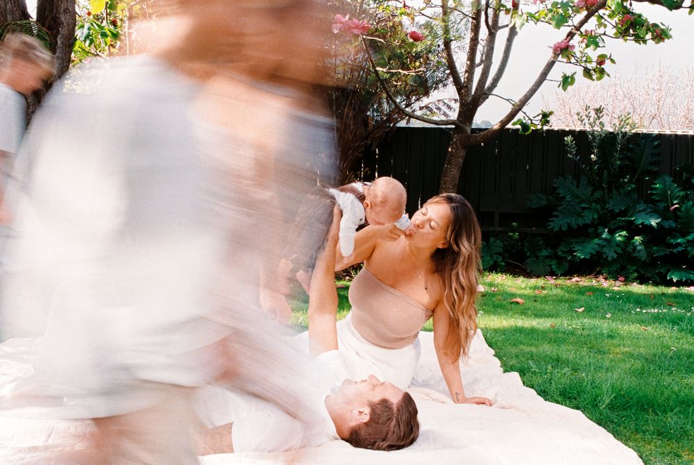 Motion-blurred photography sequence capturing joyful family moments in a sunlit outdoor space.