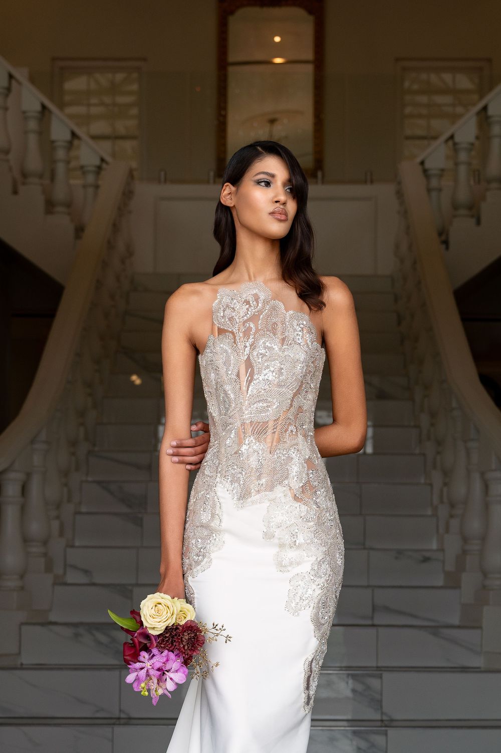 Close-up shots of an intricately detailed lace wedding gown with sheer elements and floral bouquet accents.