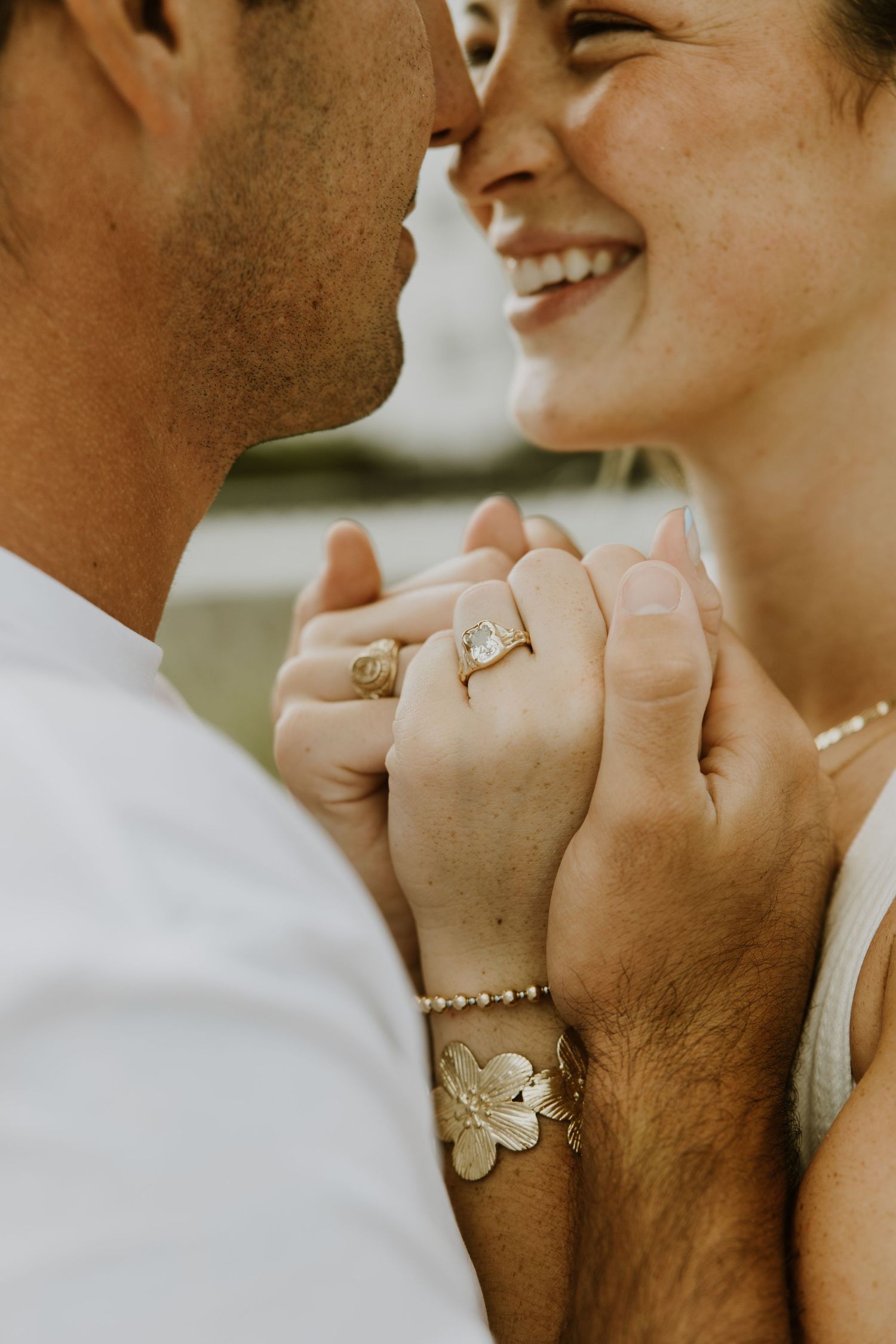 Summer engagement session on the beach in Juno. Couple portraits by the pier, in water, and in the golden sunrise light