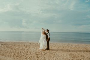 Romantic beach scene captured in seven connected photos showing figures against sandy shore and cloudy seaside backdrop.