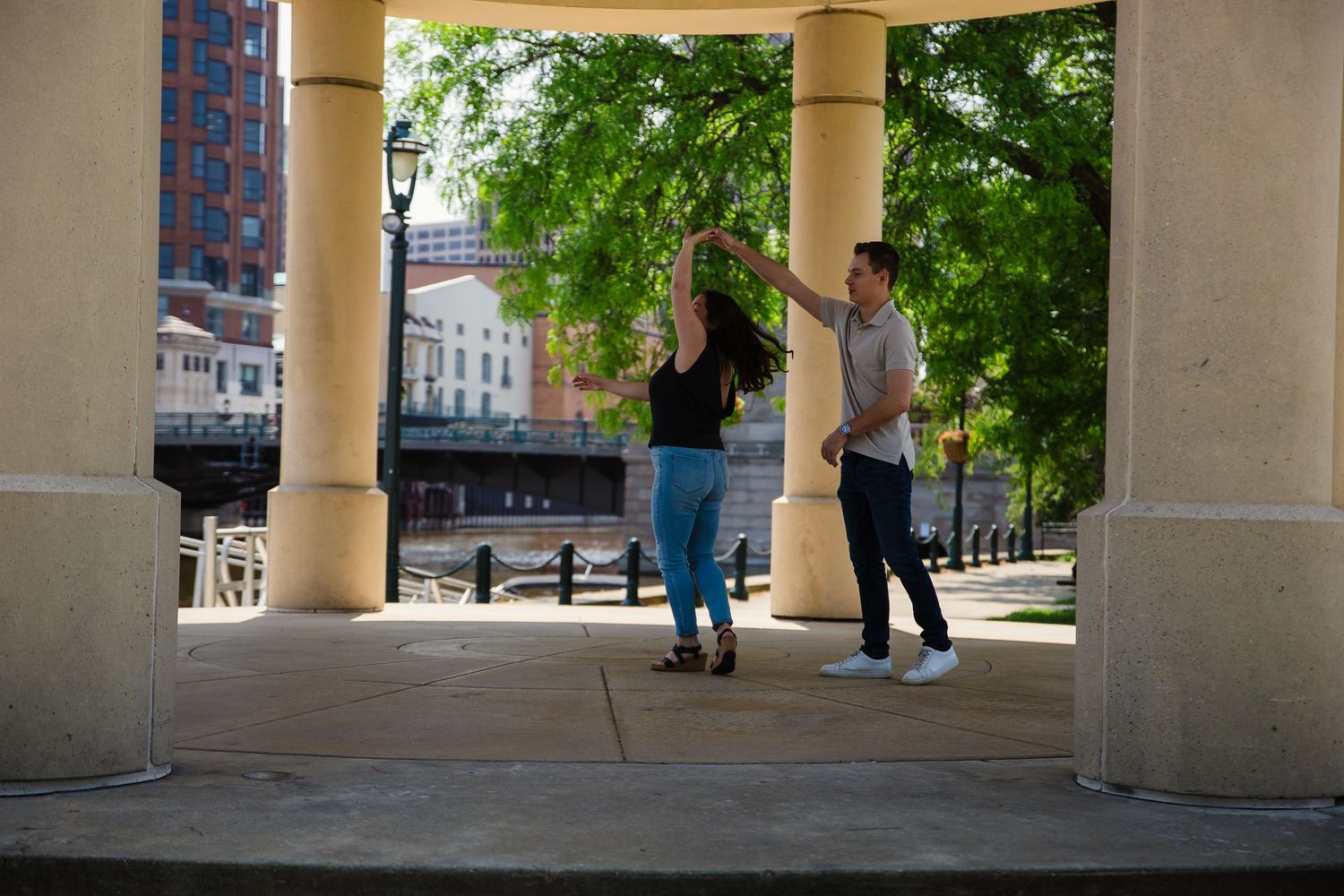 Architectural view of colonnade with pillars and walkway in urban setting.