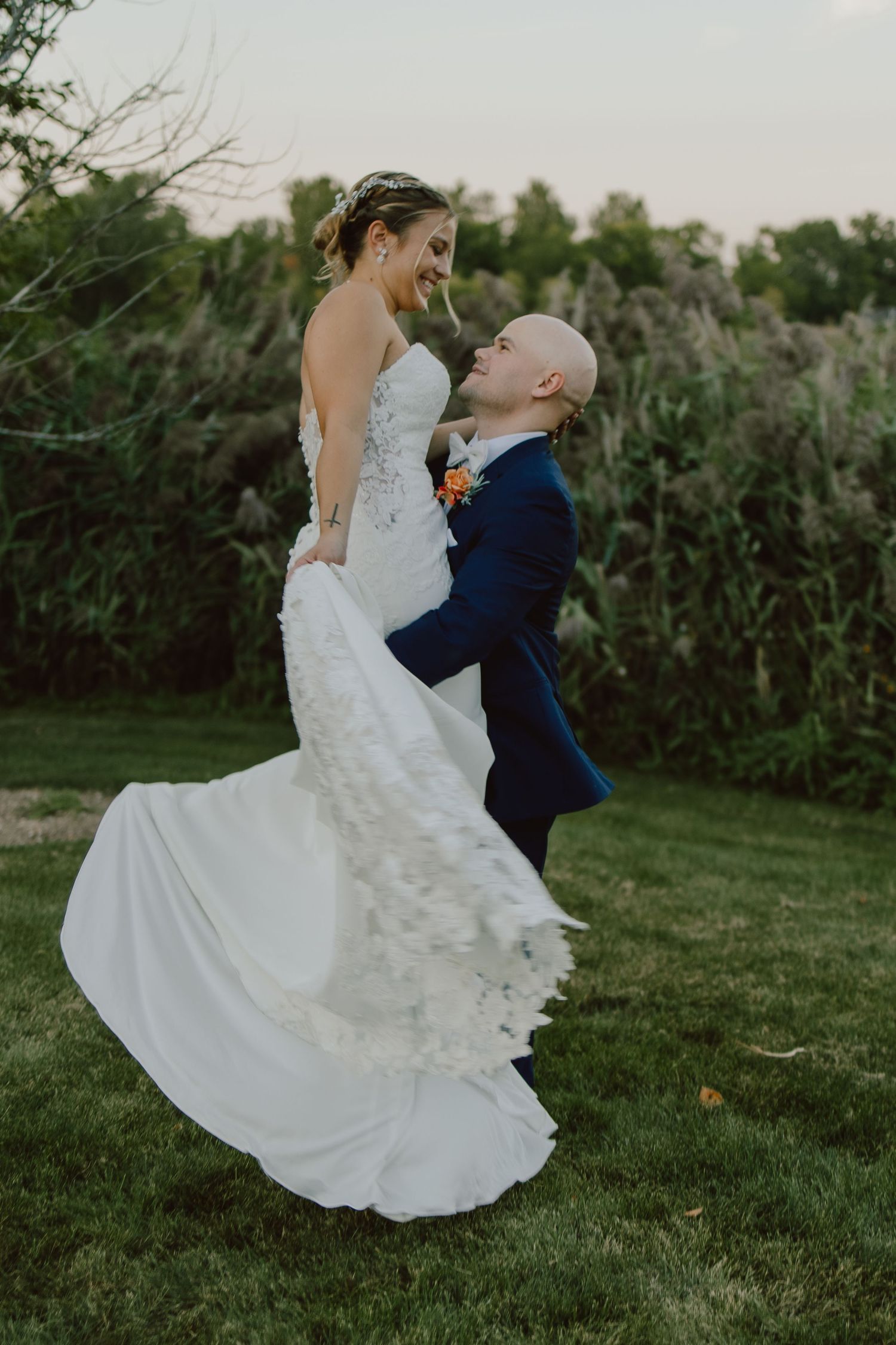 A joyful wedding moment captured in a series of photos showing a couple dancing and twirling on a grassy lawn at dusk.