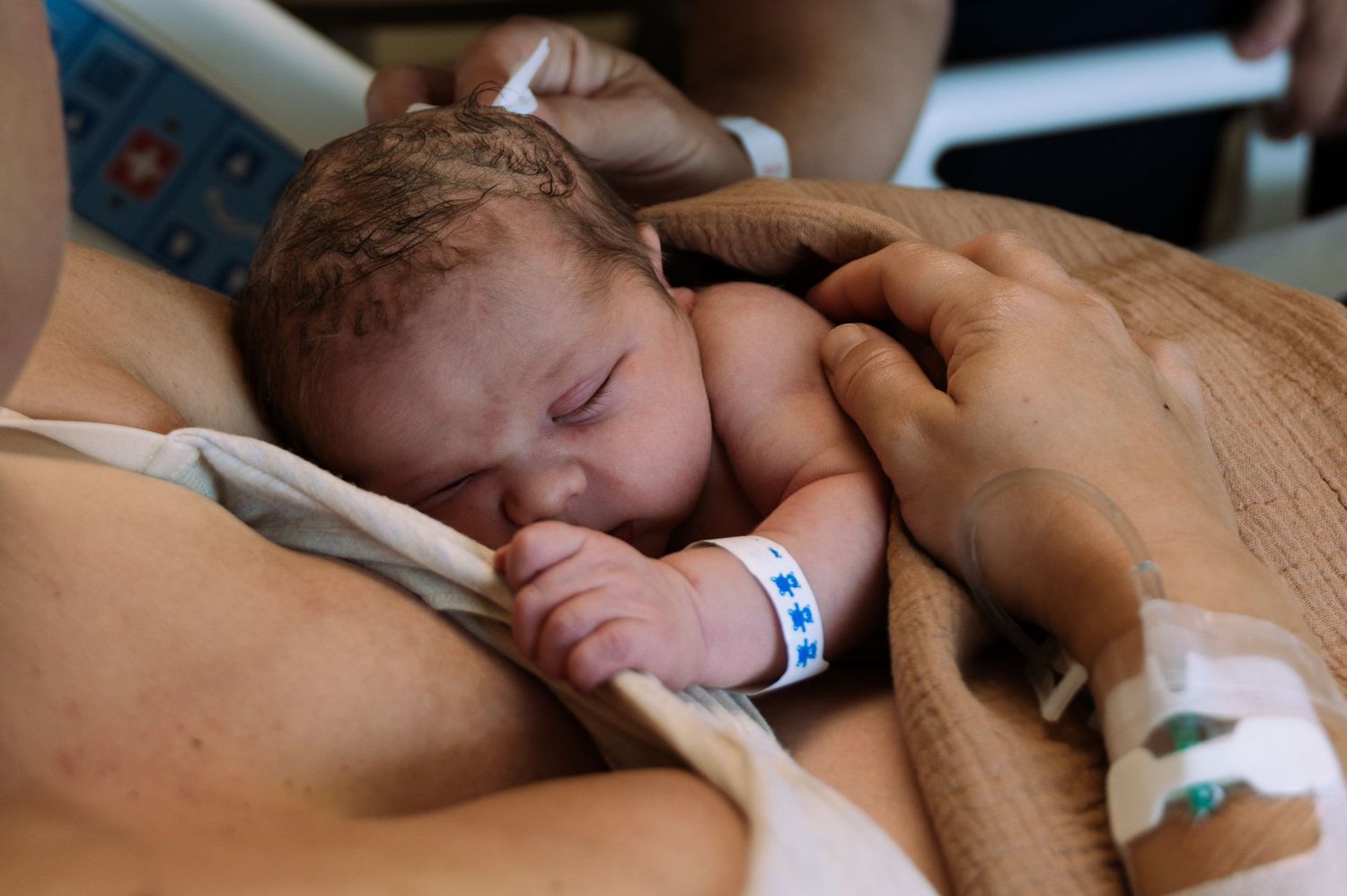 Mother holding newborn during Fresh 48 photography session