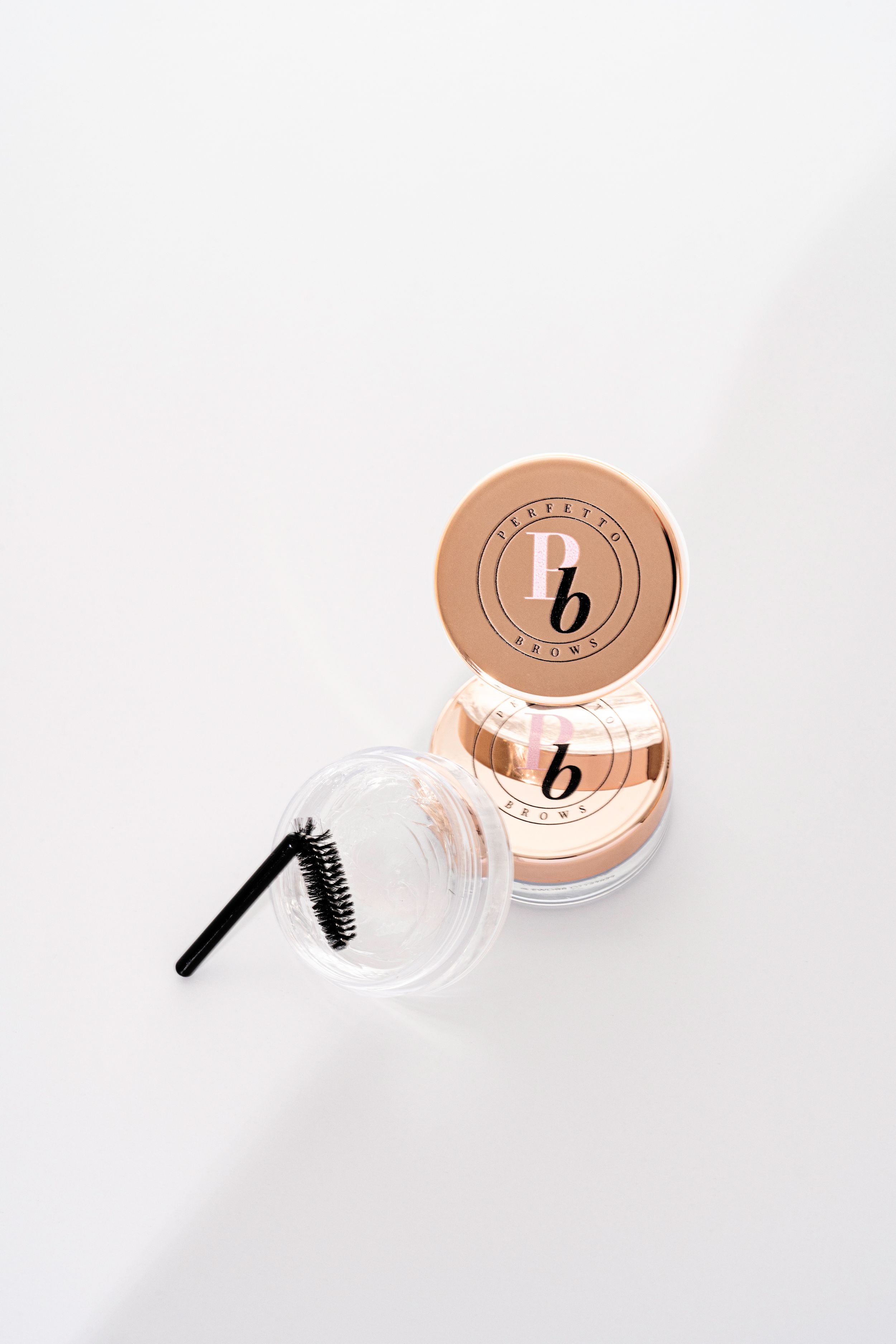 Three images of clear cosmetic jars with copper metallic lids against a white background show different product angles.