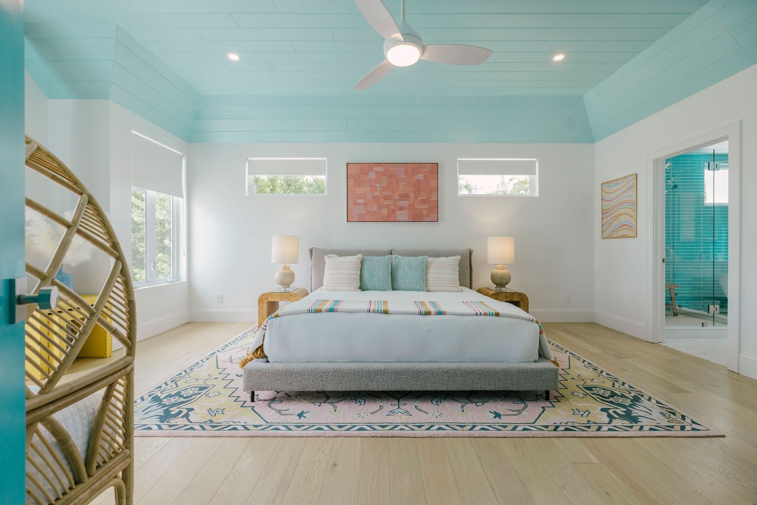 Modern minimalist beach house interior featuring turquoise accents and clean white furnishings.
