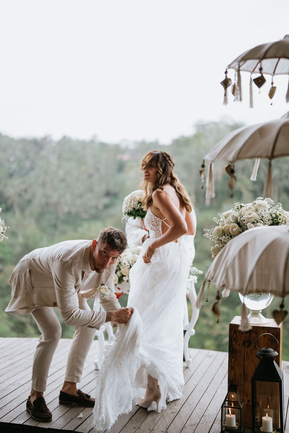 A wedding ceremony moment captured on a wooden deck with decorative umbrellas and rustic details.