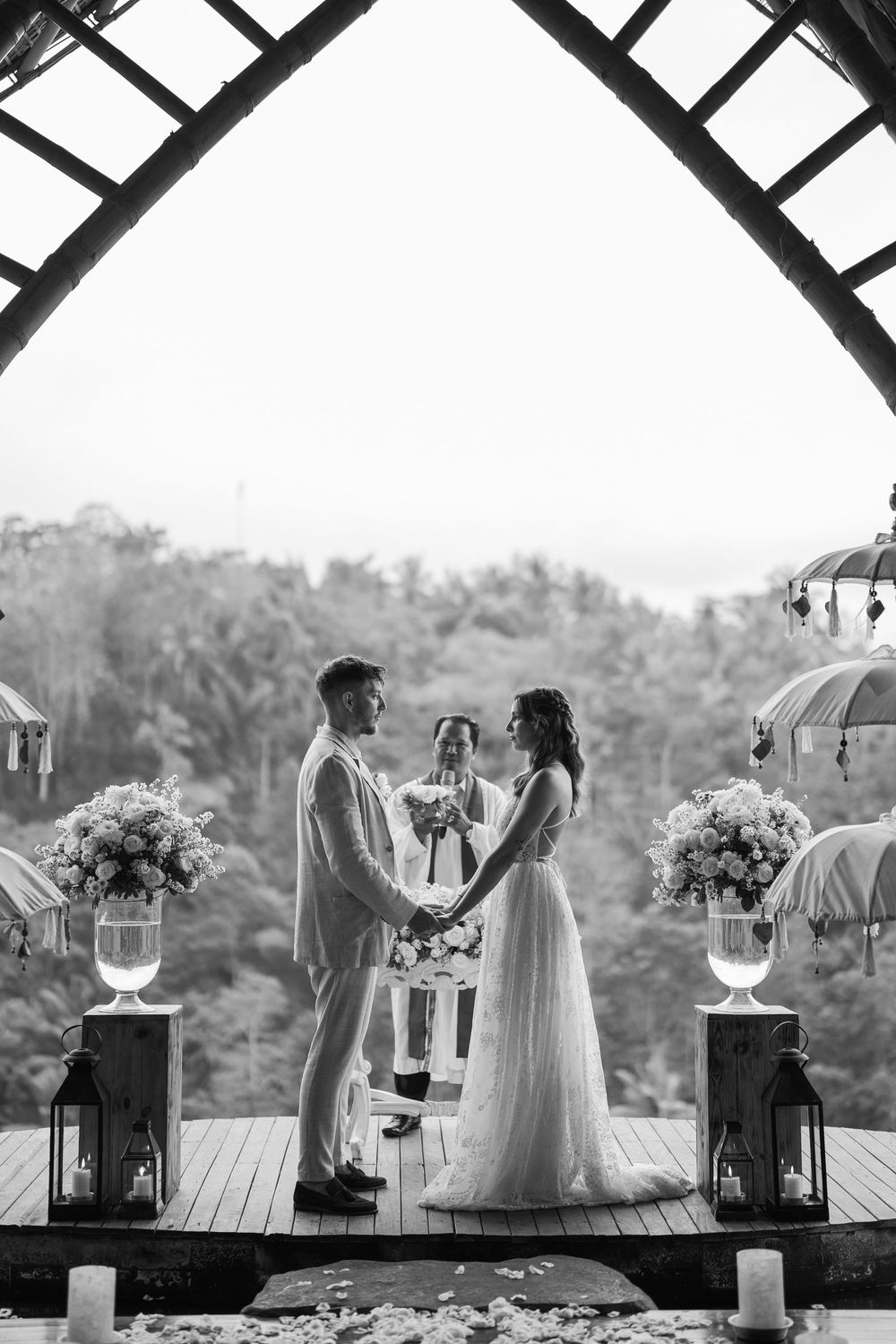 Black and white wedding ceremony photos showing intimate moments under a rustic wooden structure.