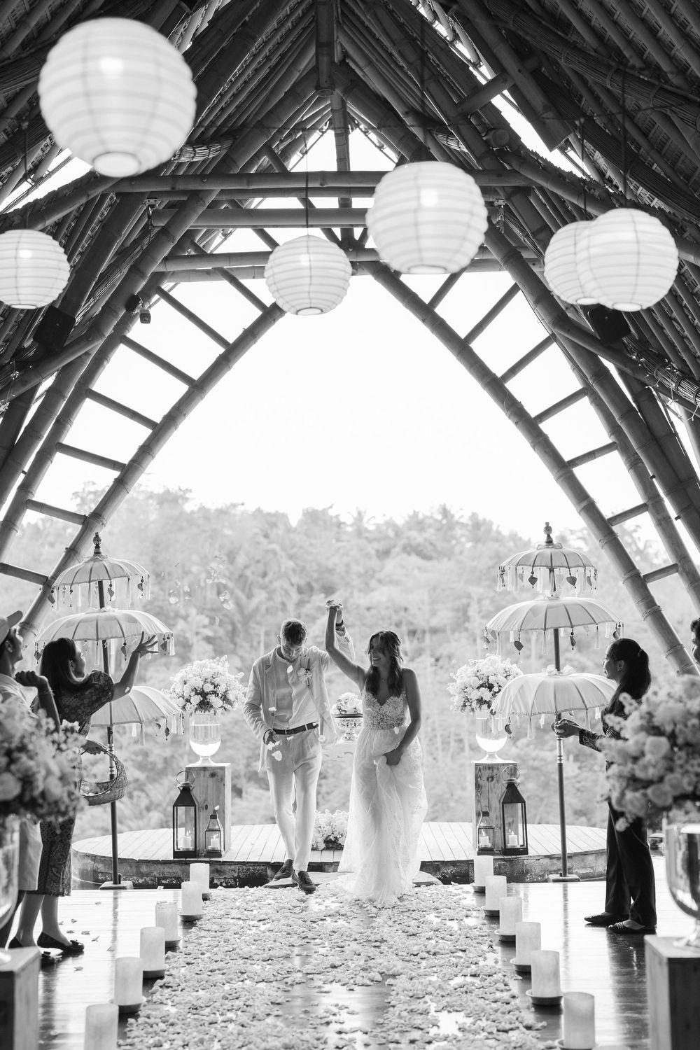 Wedding ceremony setup with paper lanterns and white umbrellas creating an ethereal atmosphere.