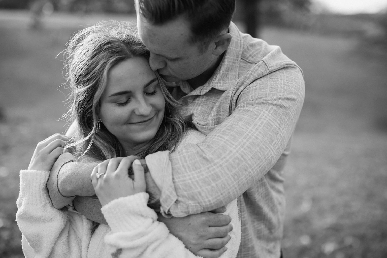 Close up of an engaged couple hugging during a romantic sunset engagement session in Fayetteville Arkansas