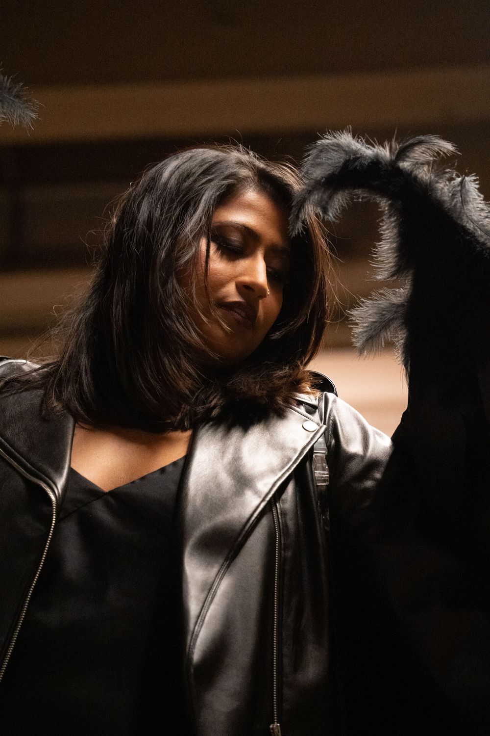 Moody portrait of someone in leather jacket with dramatic lighting.