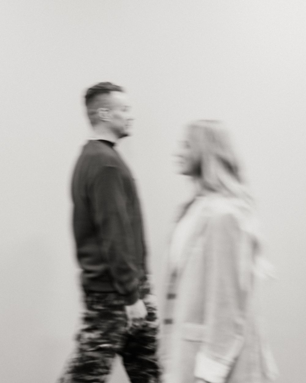 Abstract motion blur photograph of two people walking in monochrome.