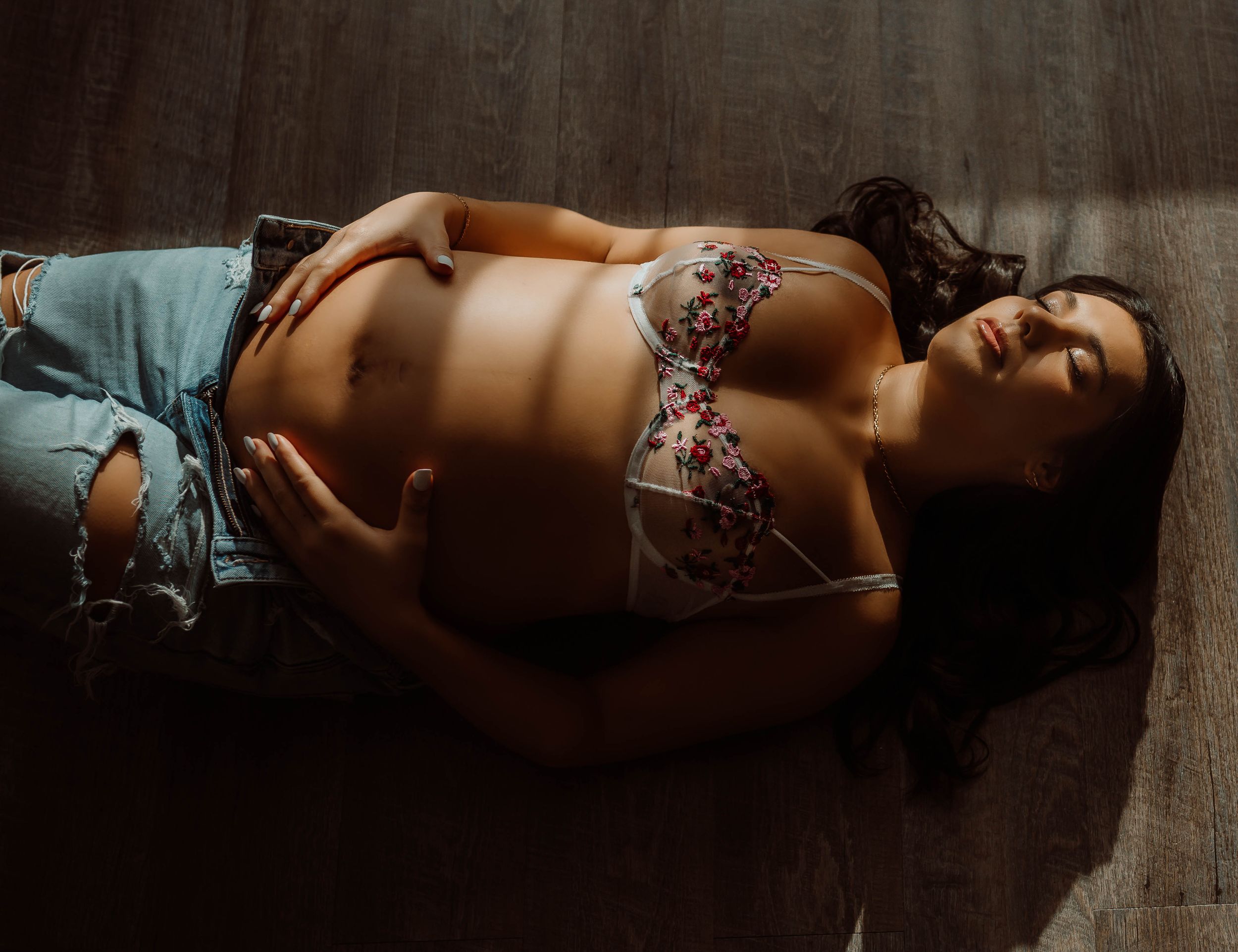 Maternity boudoir of a mother with her baby bump in soft natural light - Stillwater Minnesota boudoir photographer