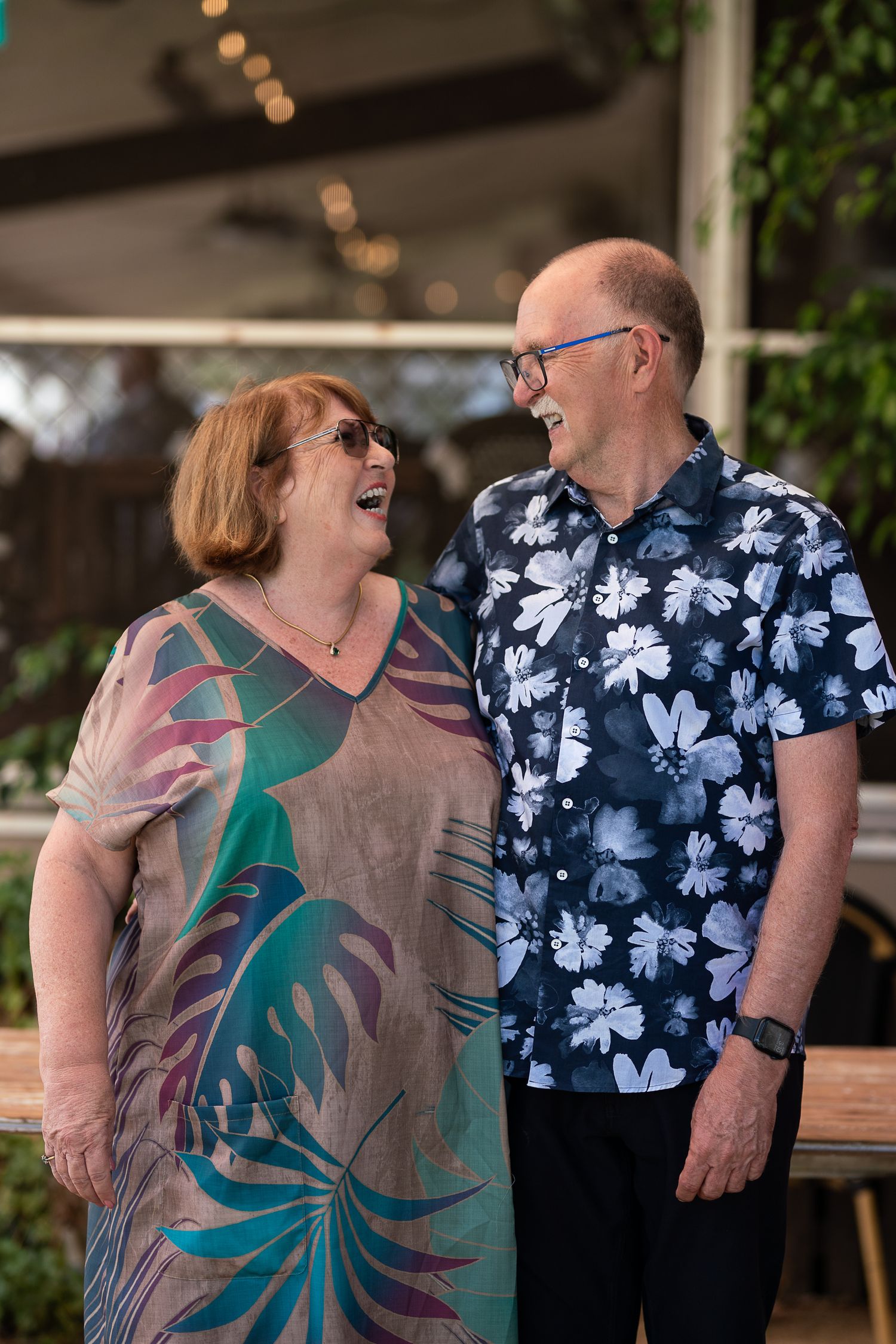 An older couple laughing together at a family celebration