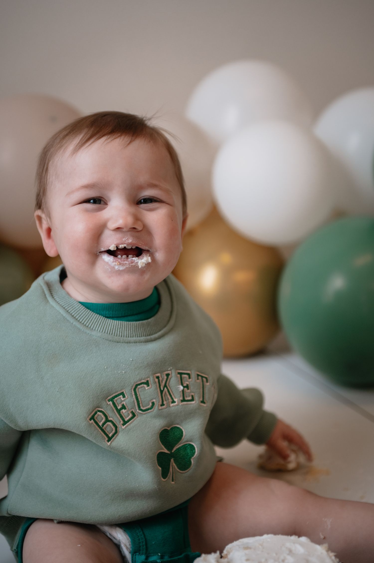Cake smash photographer in Boston MA featuring baby with cake.