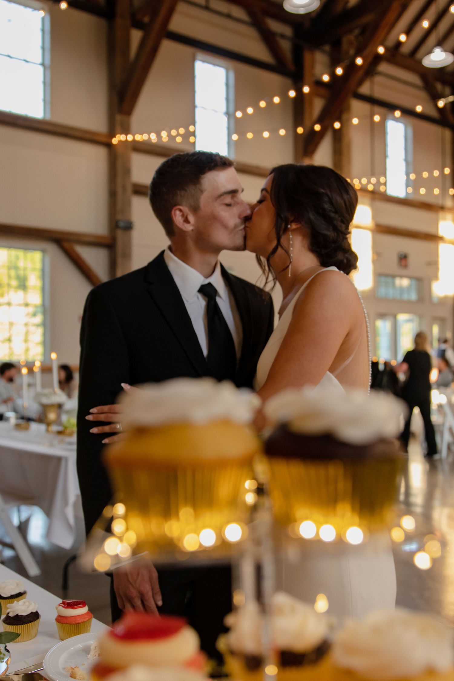 Wedding reception moments captured with string lights and glowing candles creating warm ambiance.