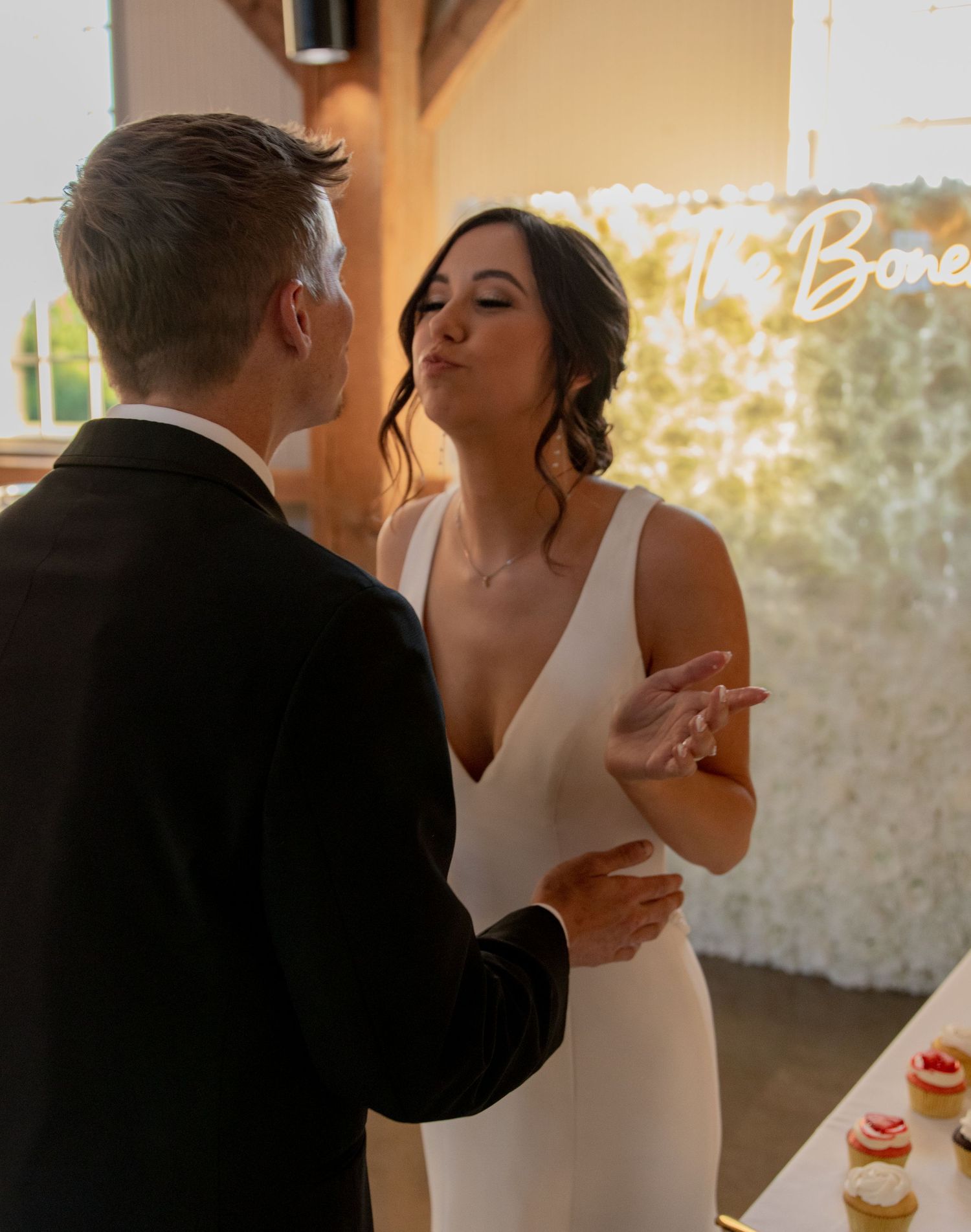 Wedding couple sharing desserts at elegant reception.