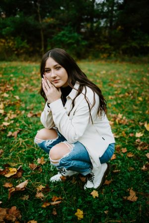 Candid outdoor portraits in a fall setting with colorful leaves on the ground.
