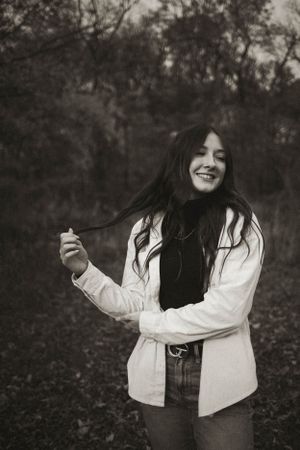 Black and white series showing joyful movement and expressions in a natural setting.