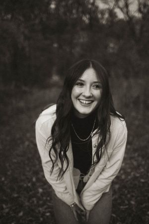 Black and white portraits capturing genuine smiles and natural poses outdoors.
