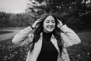 Black and white series showing playful expressions and movements in an outdoor setting.