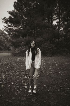 Black and white photos capturing casual poses against a backdrop of pine trees.