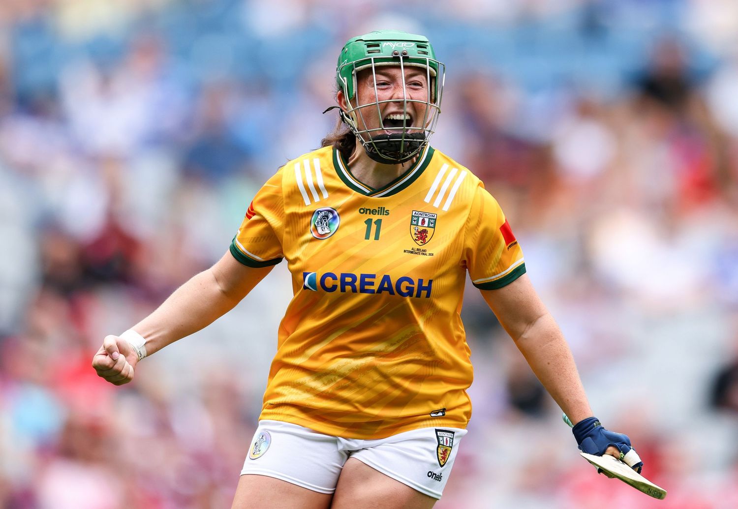 Antrim camogie player in yellow jersey celebrating during a match at Croke Park.