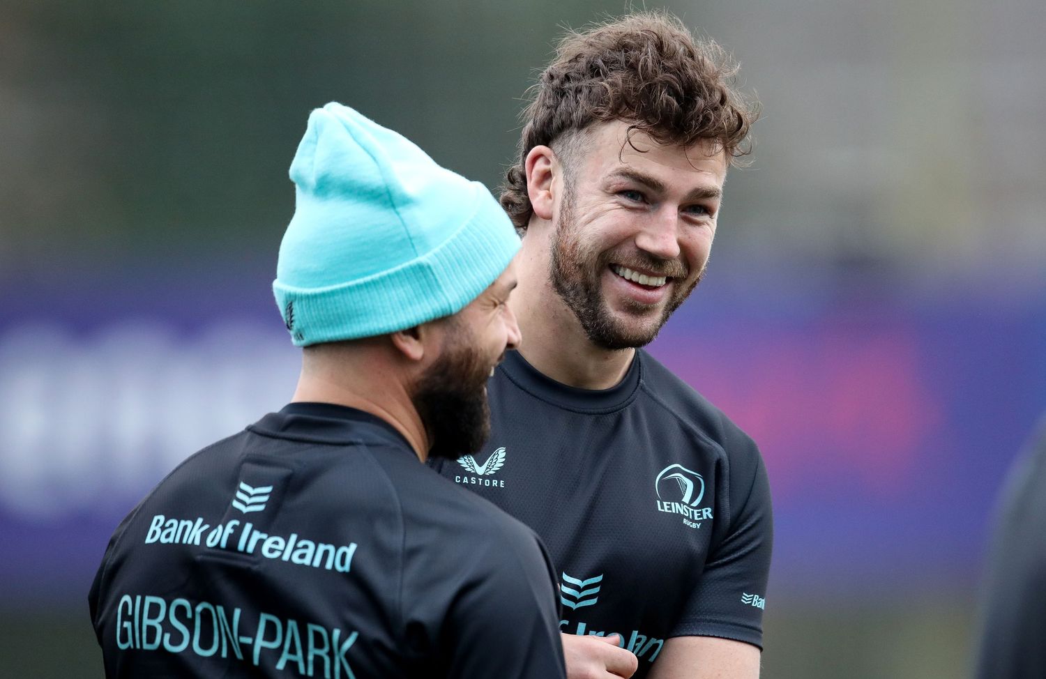 Rugby players share a laugh during team training session.