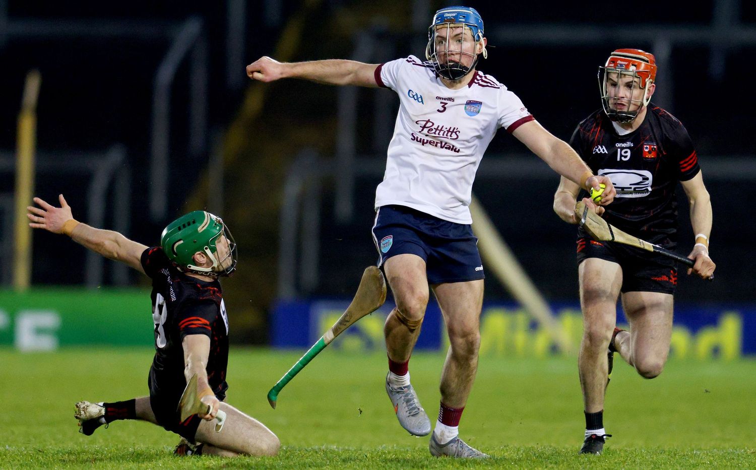 Rugby players battling for possession during a match on the field.