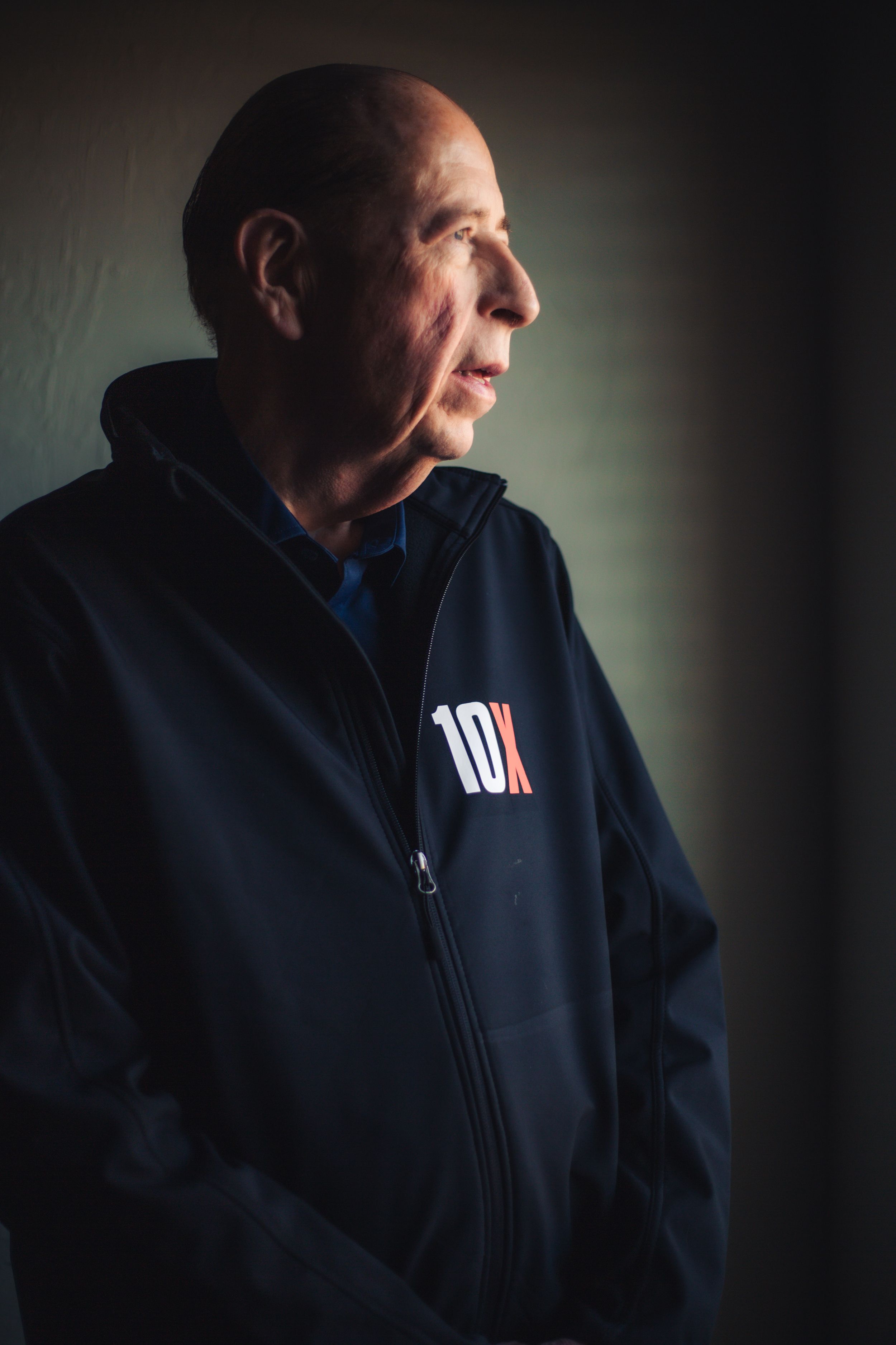 Branding headshot of older gentleman in studio with warm tones