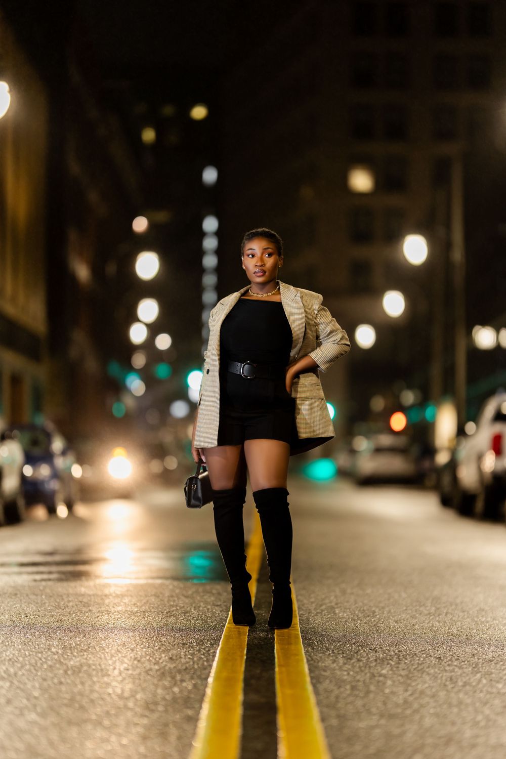 Nighttime street photography with yellow road markings and city lights.