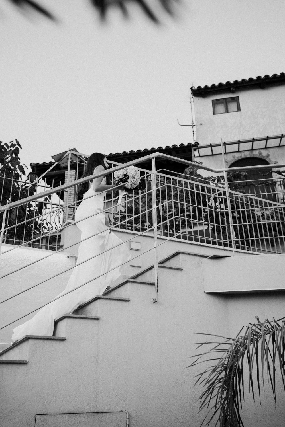 Bride walking up the stairs in her destination wedding venue in Italy