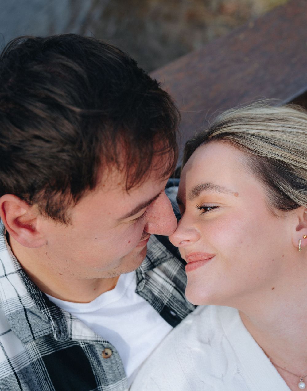 Close-up romantic portrait of couple in casual attire.
